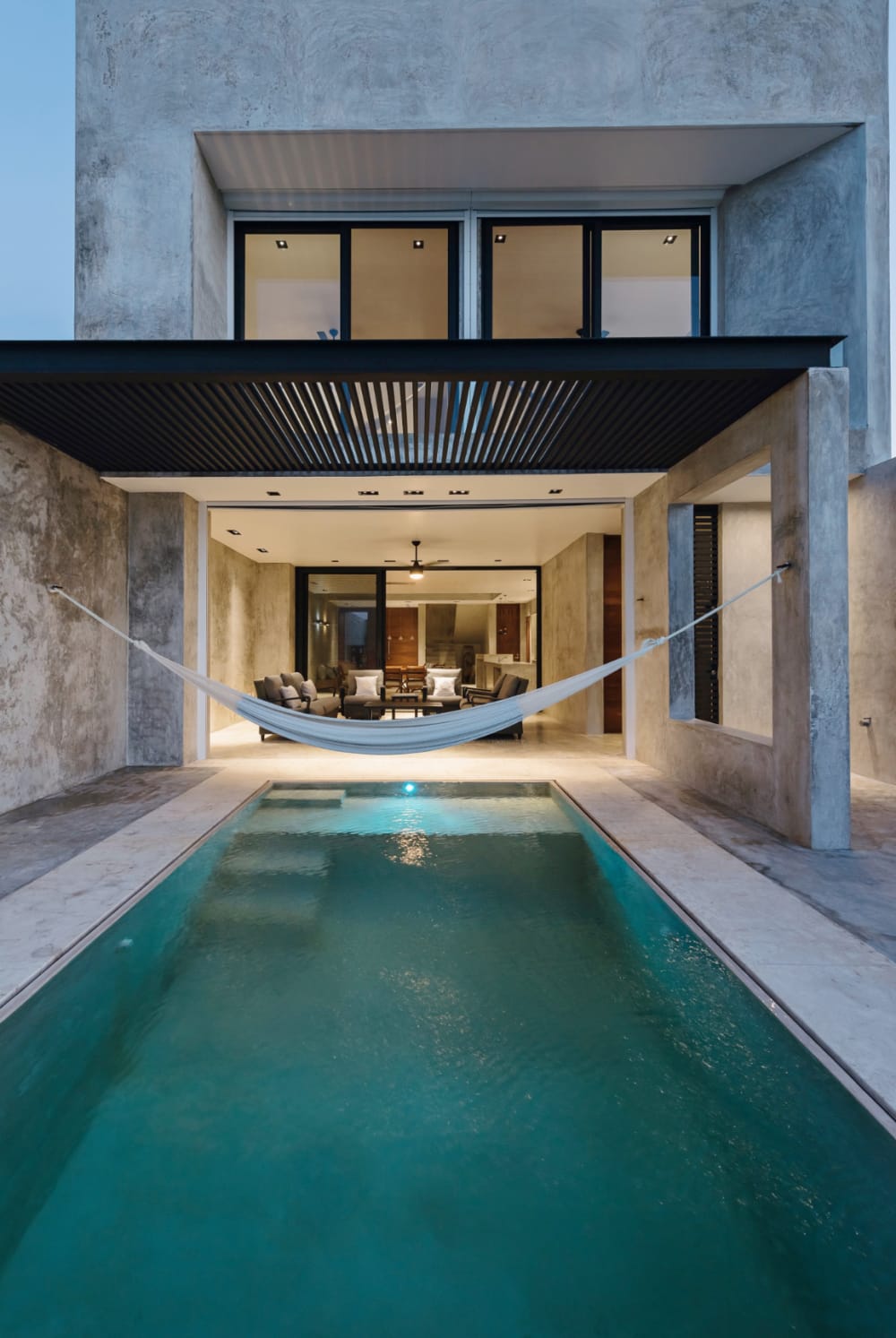 Hammock hanging over a pool.<span class="sr-only"> (opened in a new window/tab)</span>