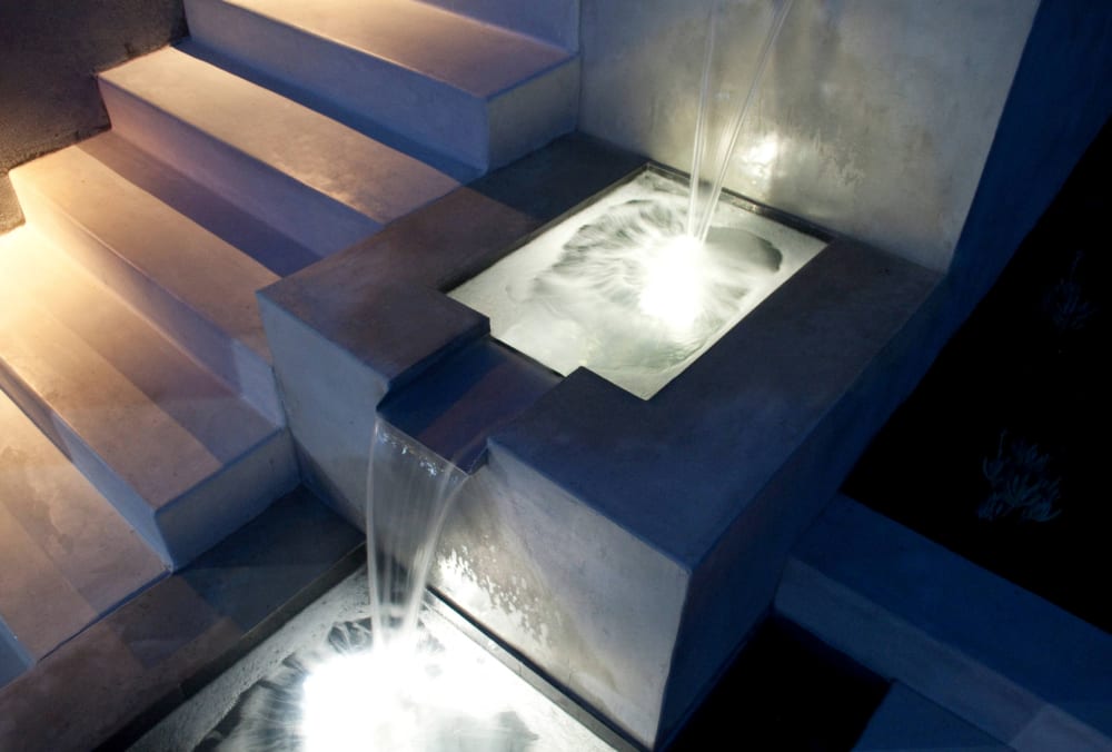 Fountain on the side of a concrete staircase.<span class="sr-only"> (opened in a new window/tab)</span>