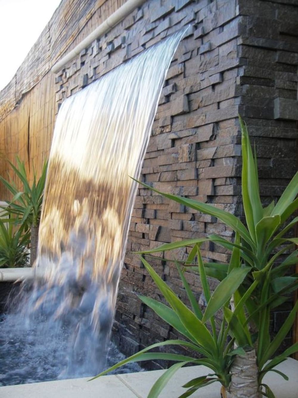 Outdoor waterfall feature.<span class="sr-only"> (opened in a new window/tab)</span>