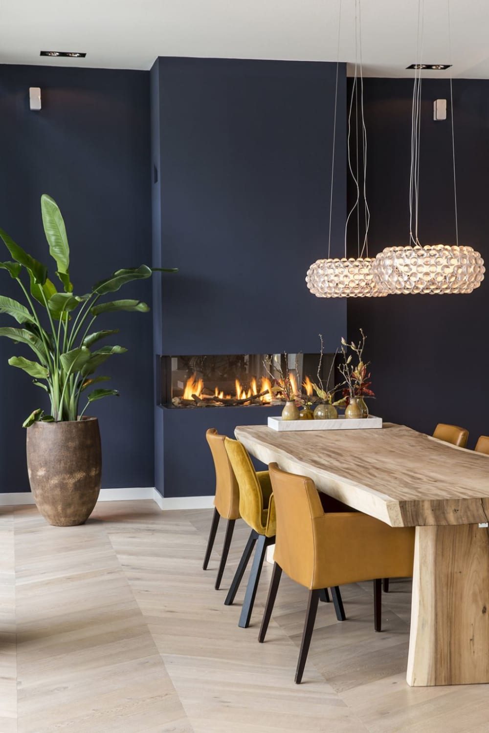 Dining room with blue wall, rustic wood table and big fireplace.<span class="sr-only"> (opened in a new window/tab)</span>