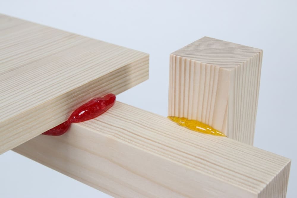 Close up of the wooden pieces kept together with a candy-based glue.<span class="sr-only"> (opened in a new window/tab)</span>