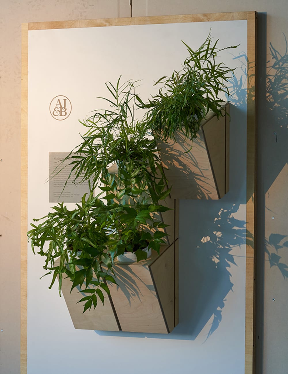 Wood panel housing vases for a vertical garden.<span class="sr-only"> (opened in a new window/tab)</span>