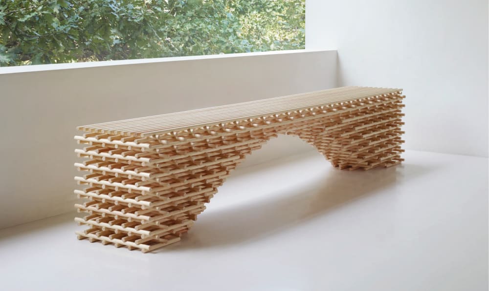 A bench made of interlocked wooden dowels.<span class="sr-only"> (opened in a new window/tab)</span>