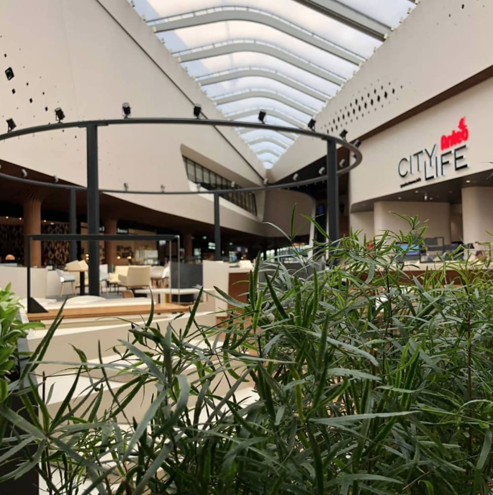 Indoor view of CityLife shopping district, an example of biophilic design.<span class="sr-only"> (opened in a new window/tab)</span>