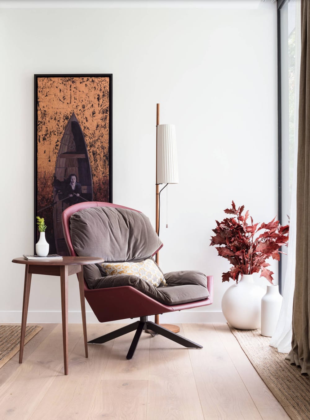 Relaxing armchair corner with branches of red leaves in a vase.<span class="sr-only"> (opened in a new window/tab)</span>