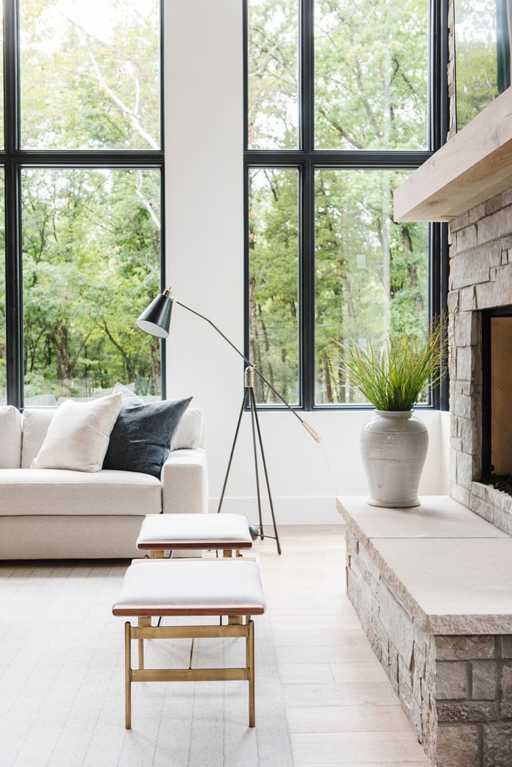 Relaxing sofa with a huge window behind with a view on nature.<span class="sr-only"> (opened in a new window/tab)</span>