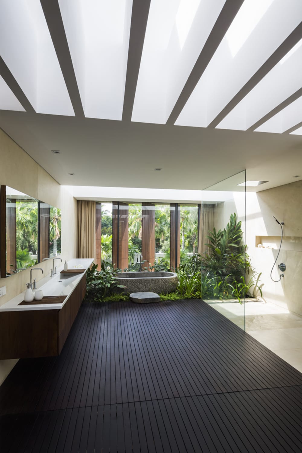 Bathroom facing a huge window with plenty of plants down the bathtub.<span class="sr-only"> (opened in a new window/tab)</span>