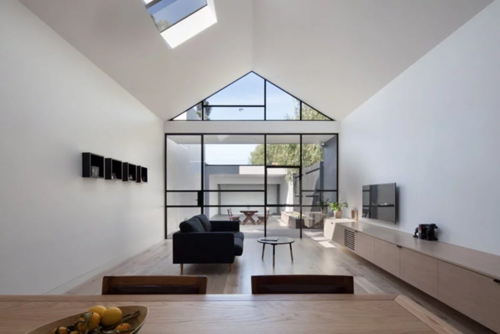 Open plan minimal apartment, with uninterrupted view from the kitchen to the patio, great example of biophilic design.<span class="sr-only"> (opened in a new window/tab)</span>