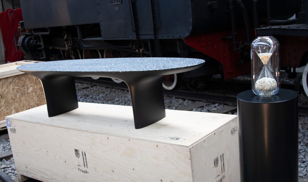 Hourglass and bench made recycling ocean plastic.<span class="sr-only"> (opened in a new window/tab)</span>