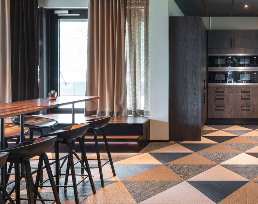 Dining space with recycled vinyl floor in a pattern that resembles wood.<span class="sr-only"> (opened in a new window/tab)</span>