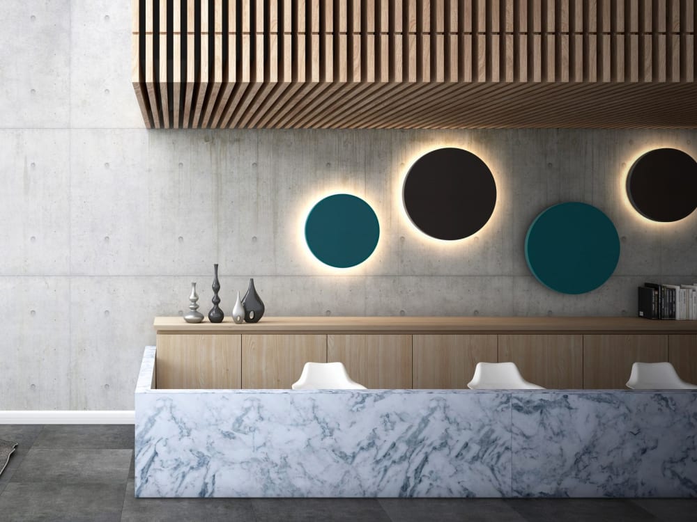 Contemporary room with round colorful acoustic panels with integrated backlight used as art.<span class="sr-only"> (opened in a new window/tab)</span>