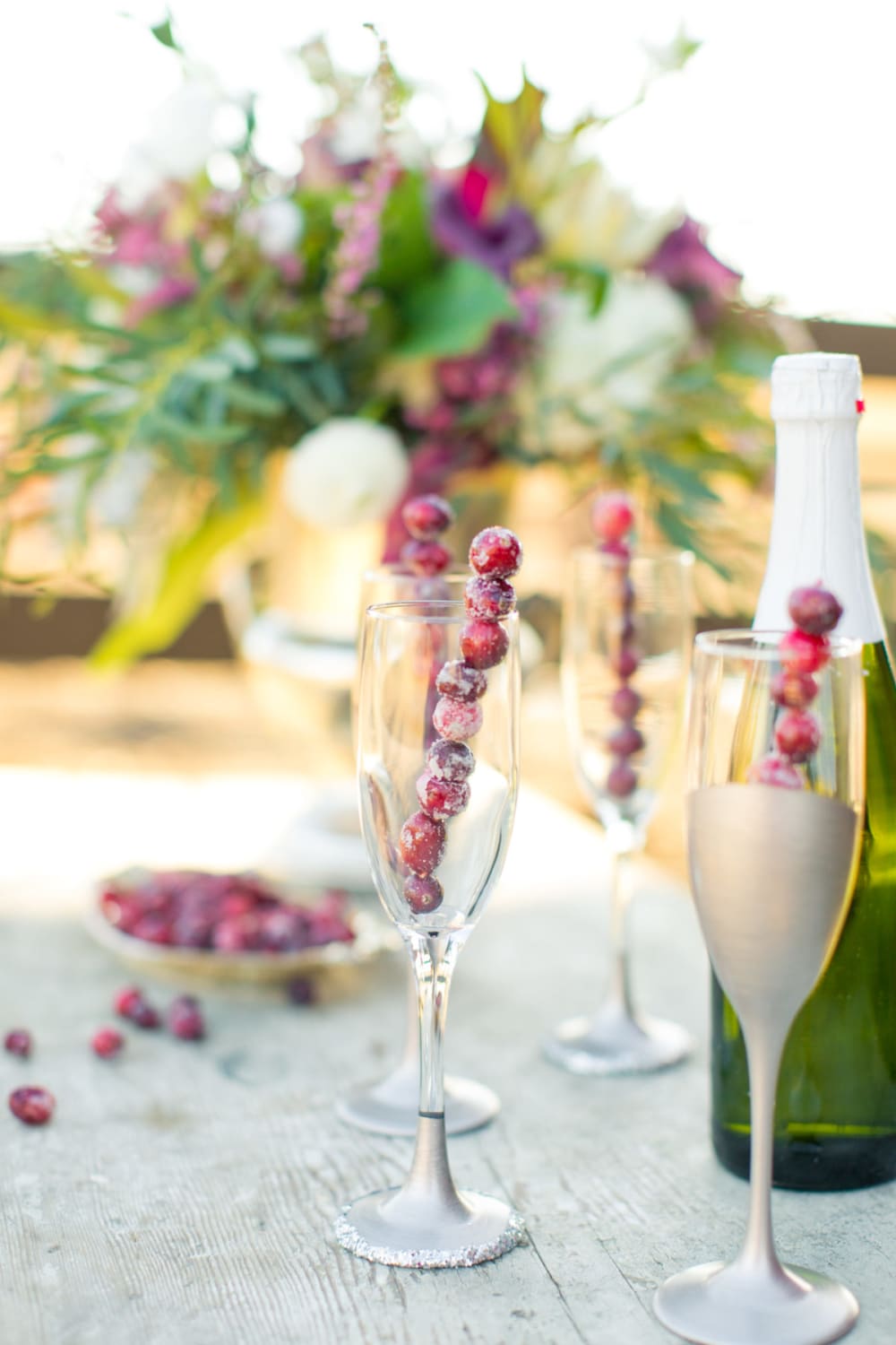 A stick made of frozen cranberries adds a festive vibes when put into a champagne glass.<span class="sr-only"> (opened in a new window/tab)</span>