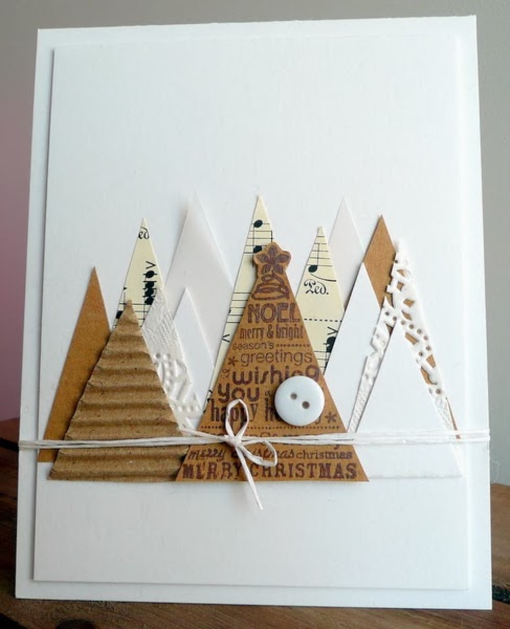 White Christmas card decorated with triangular cut-outs representing Christmas trees.<span class="sr-only"> (opened in a new window/tab)</span>