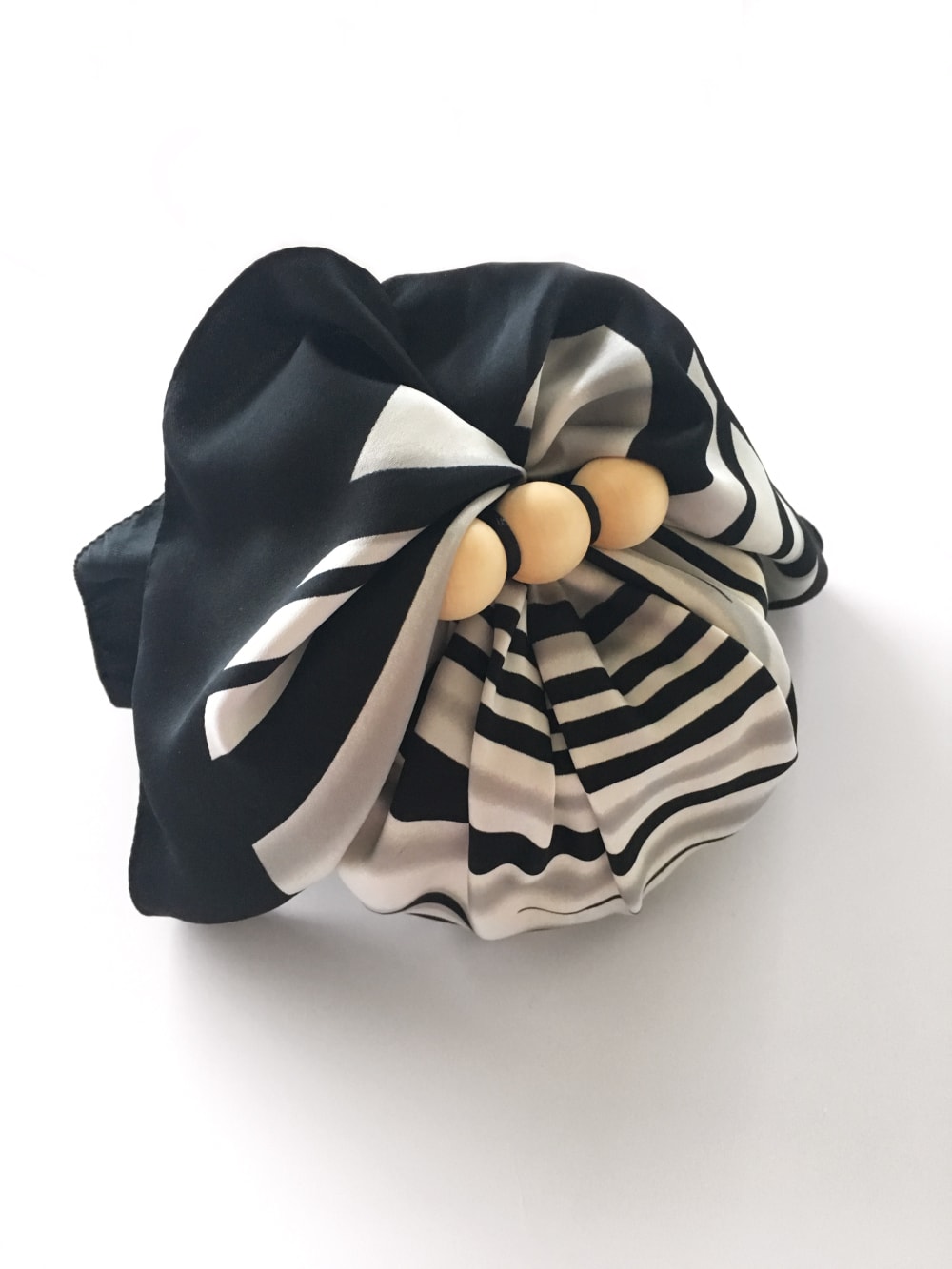 Gift wrapped into a scarf as an example of sustainable gift wrapping.<span class="sr-only"> (opened in a new window/tab)</span>