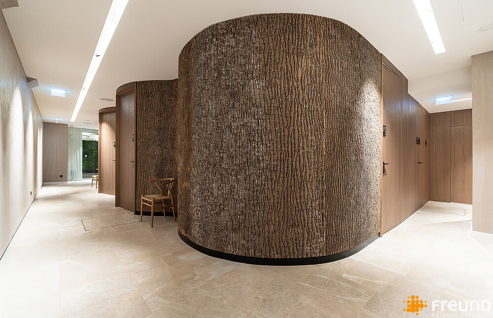 Corridor with curved walls entirely covered with poplar bark panels.<span class="sr-only"> (opened in a new window/tab)</span>