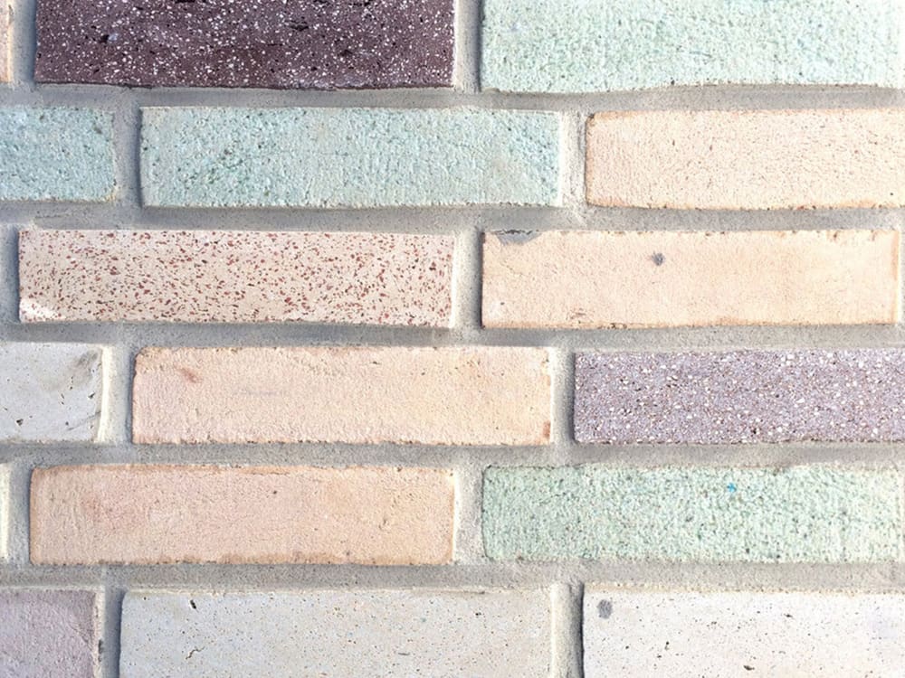 A wall of colourful and sustainable bricks.<span class="sr-only"> (opened in a new window/tab)</span>