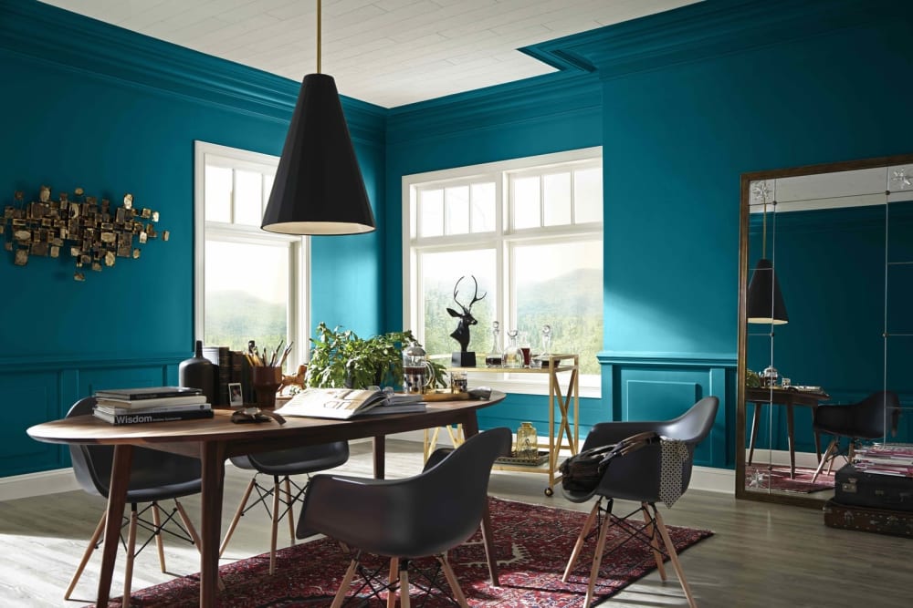 Living/dining area. All walls painted in Oceanside (2018 colour of the year by Sherwin Williams), window frames in white. Neutral grey and wood furniture.<span class="sr-only"> (opened in a new window/tab)</span>