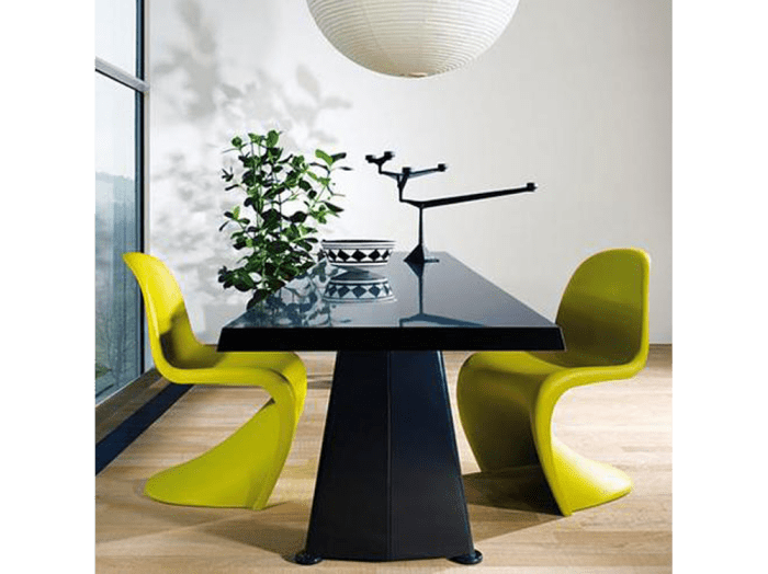 Chartreuse Panton chairs around a modern black table. Chartreuse Panton chairs around a modern black table.