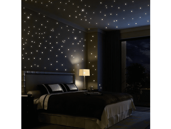 Tiny lights on the ceiling create a stunning starlight effect in this bedroom.