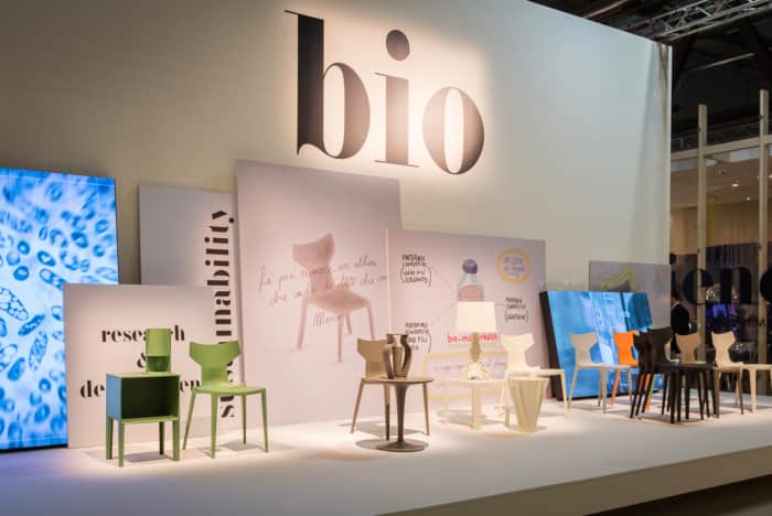 Exposition of Kartell at Milan Design Week, showing the new Bio chair and other iconic pieces, all produced with the new biopolymer.