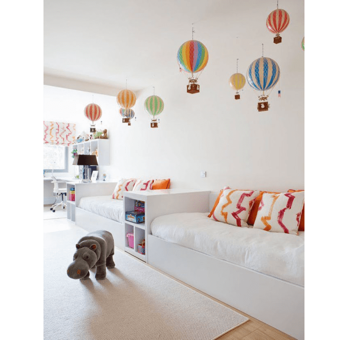 Colourful hot-air balloons drop down from a pure white ceiling. Colourful hot-air balloons dropping down from a pure white ceiling.