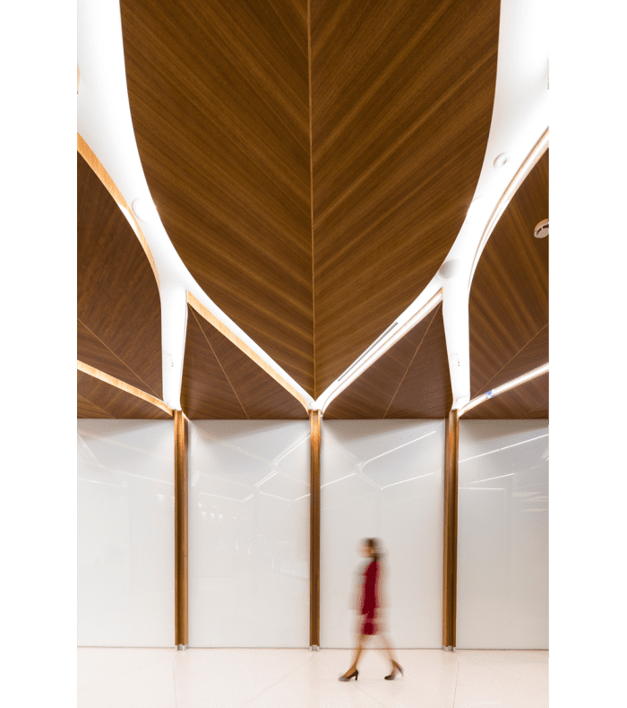 Corridor with big leaf-shaped wooden panels on the ceiling.