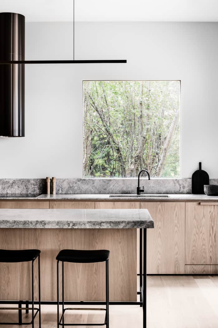 Minimalist kitchen with wood cabinets and stone countertops, great example of biophilic design. Minimalist kitchen with wood cabinets and stone countertops, great example of biophilic design.