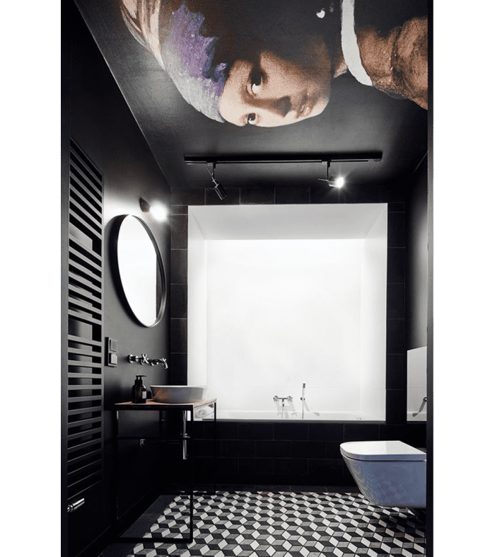 Black bathroom with a reproduction of Jan Vermeer’s painting "Girl with a Pearl Earring" on the ceiling.