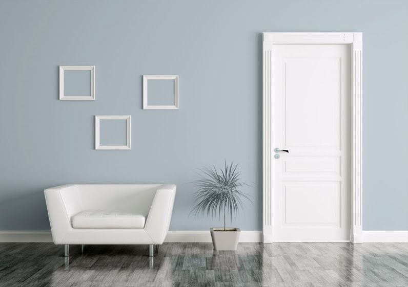 The white of an armchair, a door and three wall frames, creates a peaceful contrast with the background wall, painted in Atmospheric Pressure (2018 colour of the year by Diamond Vogel).