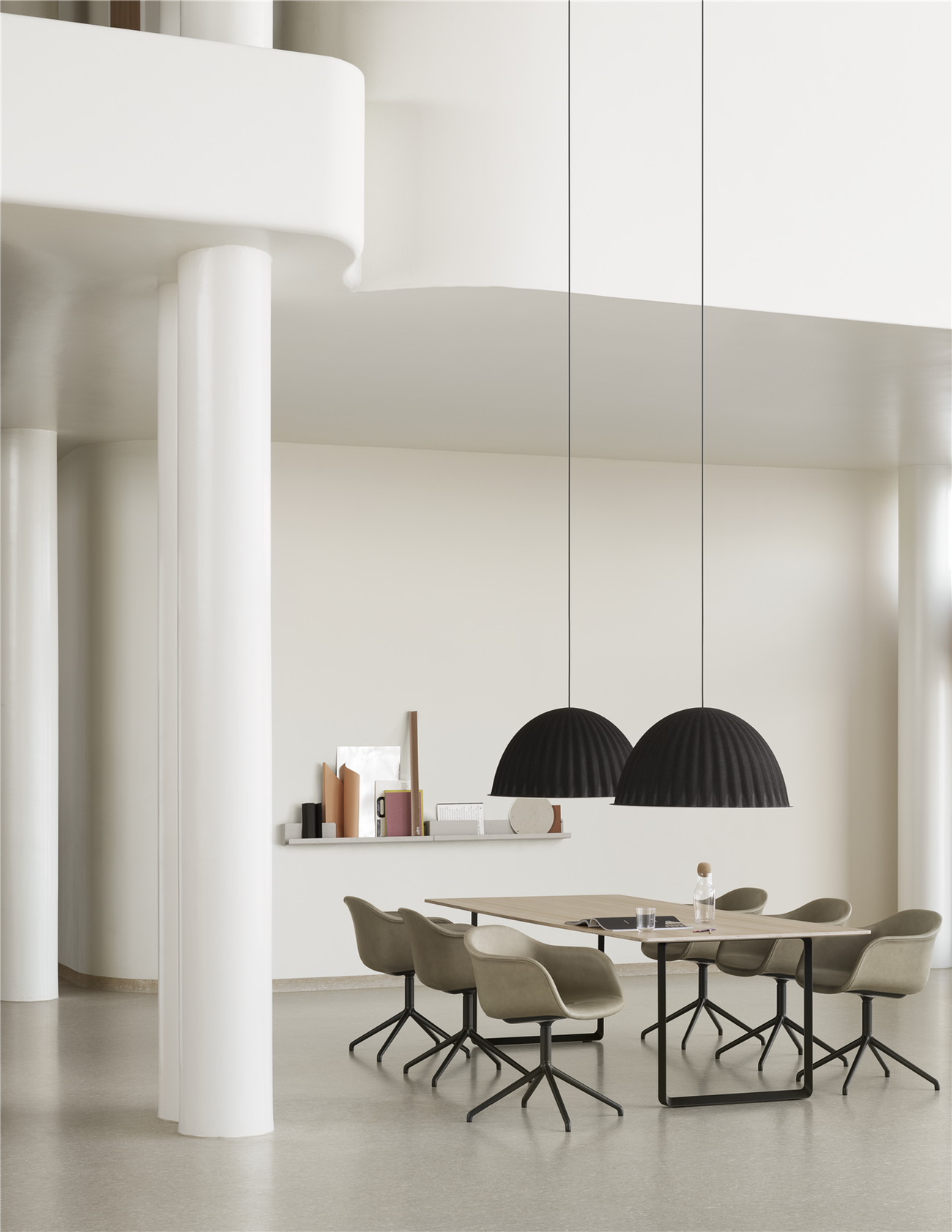 Minimal dining room with huge soudproofing pendant lights above the table.
