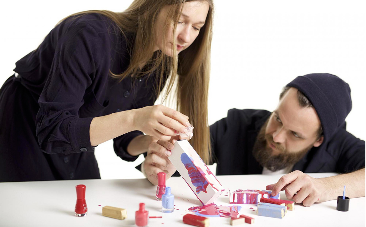 Designers experimenting with nail polish.