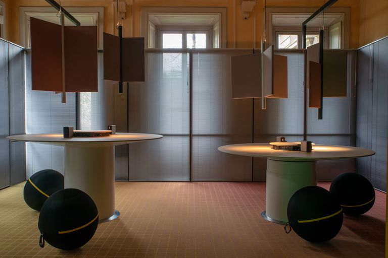 Standing working station with projectors creating touchscreens on the table itself.