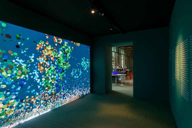 An interactive wall translating passing people into moving dots.