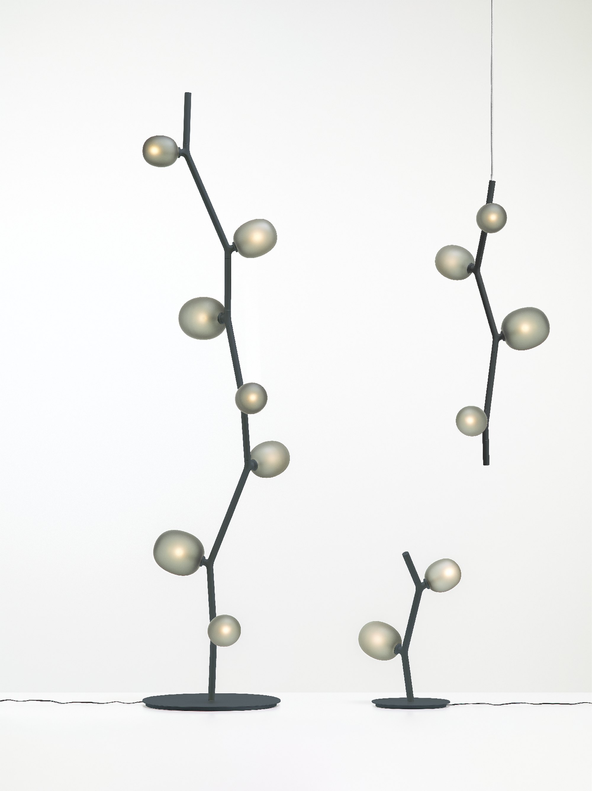 Floor lamp recalling the shape of a branch (the structure) with leaves (the bulbs).