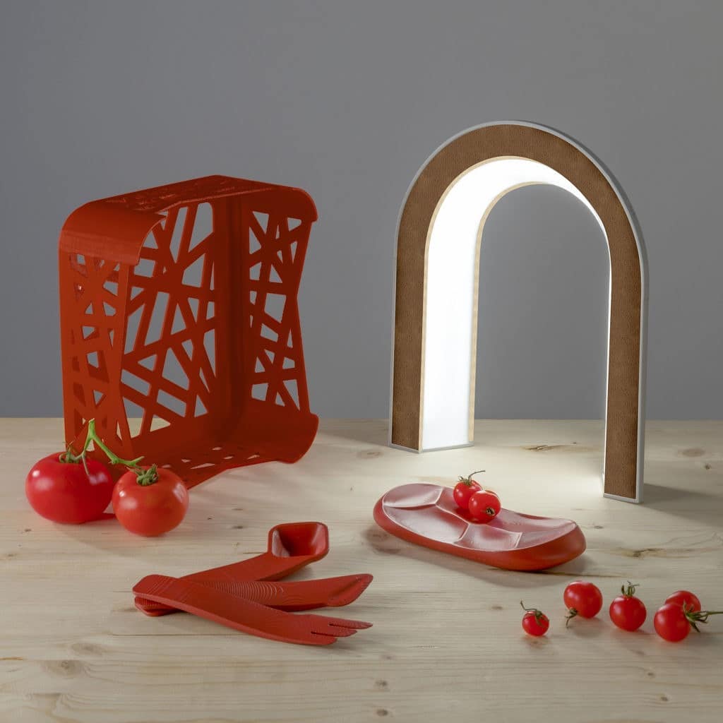 Circular design kitchen utensils: a plate, cutlery and a small crate made out of tomato peels.
