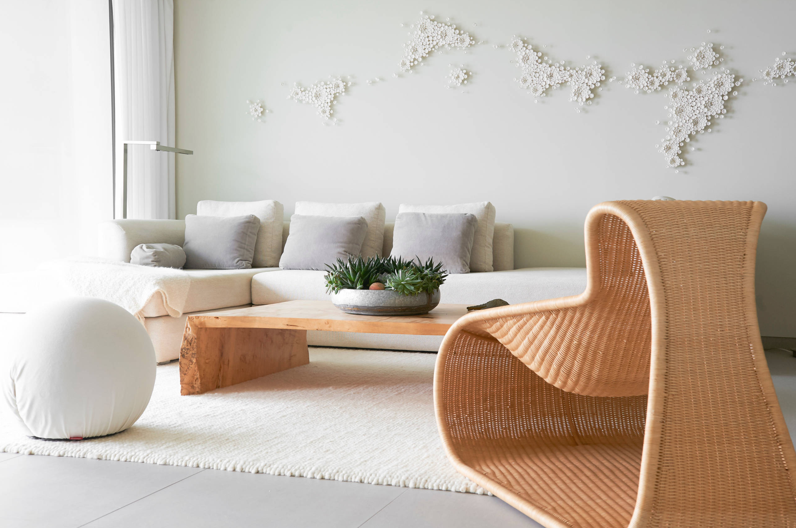 Living room with a 3D artwork on the wall that recalls natural fractals.