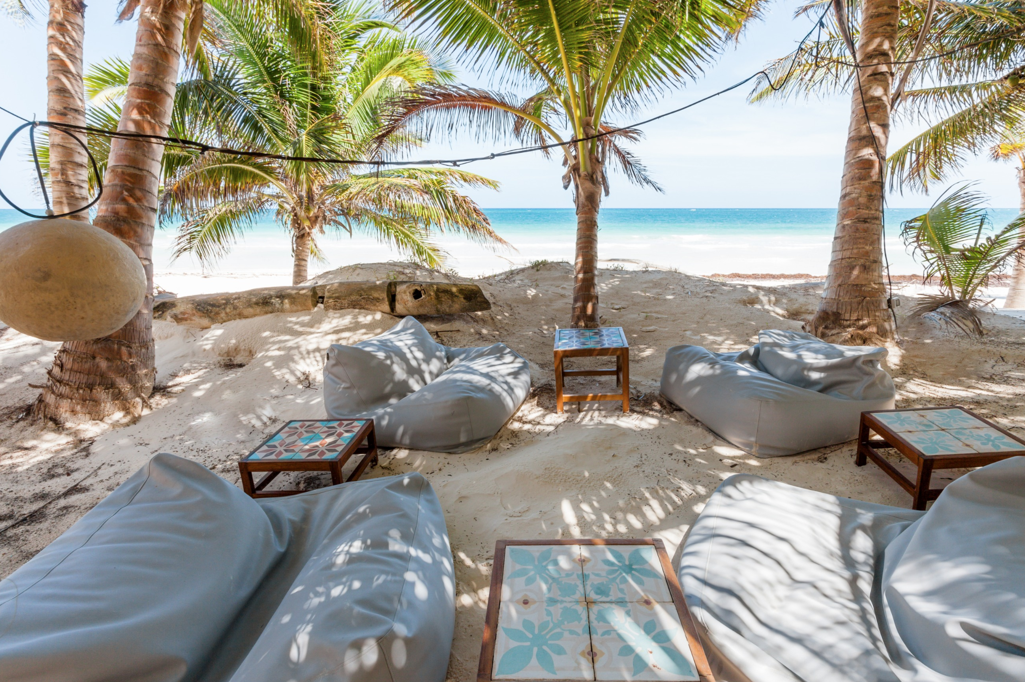 The outdoor lounging area of Casa Nalum sits directly on the beach.