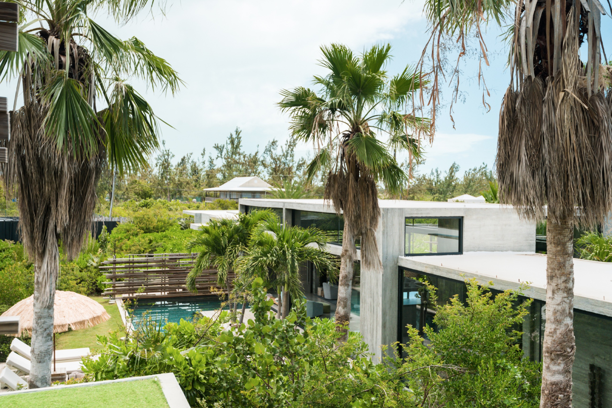 Helicopter view of Villa Islander, a biophilic design home immersed in the forest.