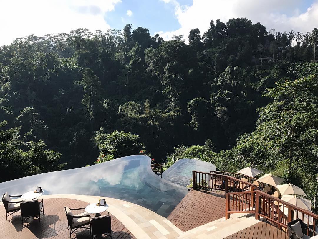 A terraced infinity pool that seems to go right into the forest.
