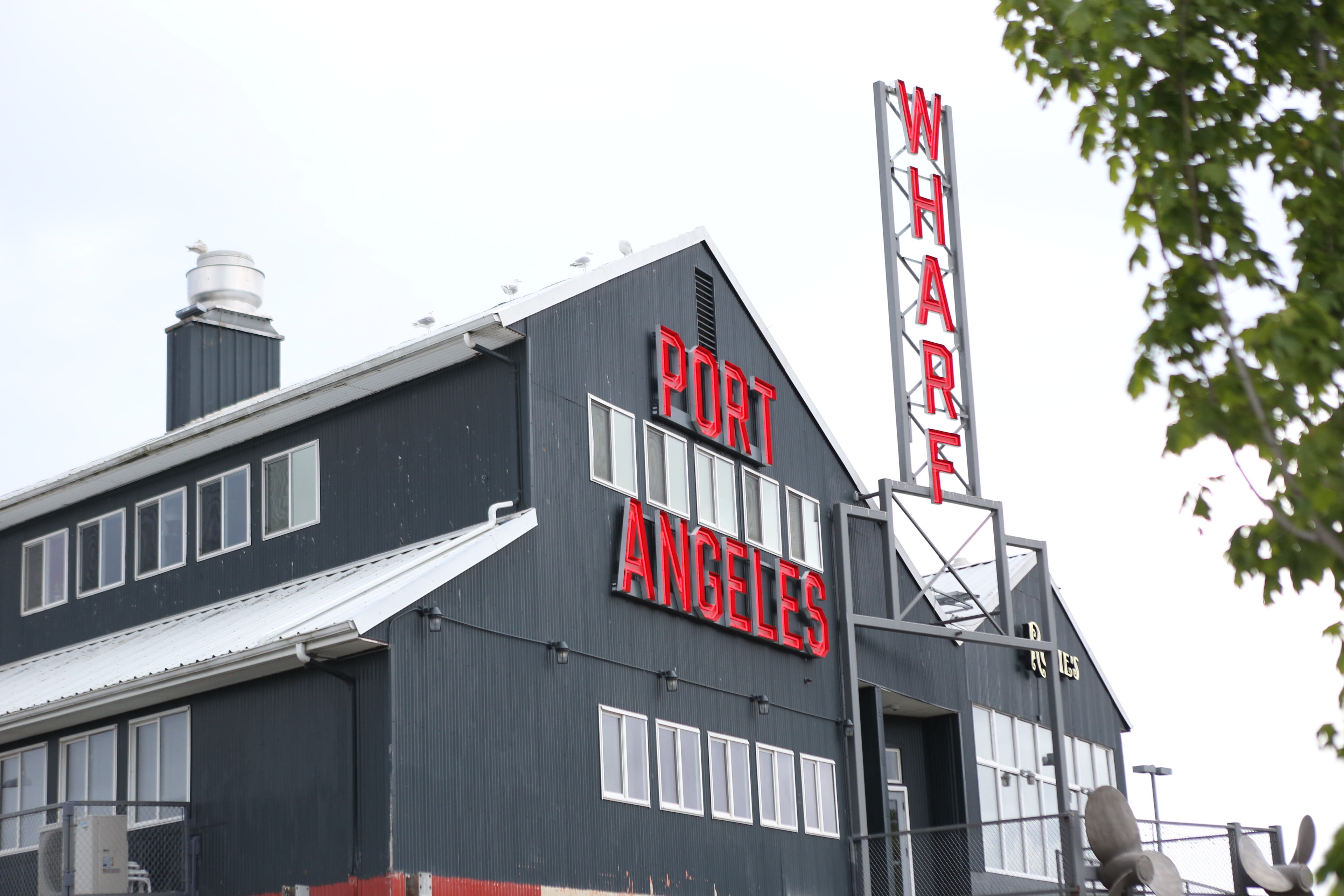 The Port Angeles Wharf sign on the waterfront in Port Angeles, Washington