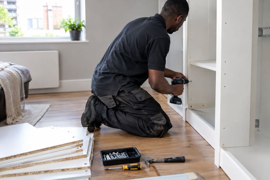 Technician assembling a flat-pack wardrobe in a London flat | Atlas South