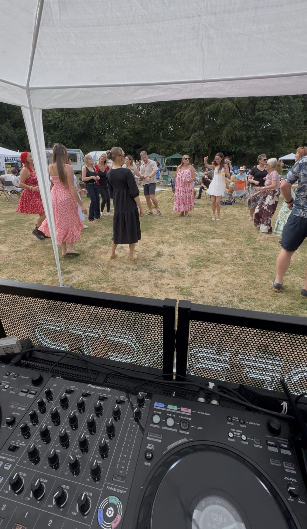 Guests packed onto the dancefloor under DFRACTD lighting at a wedding reception