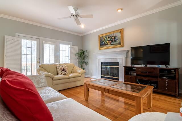 a basement soundproofed window and television in front of wooden table