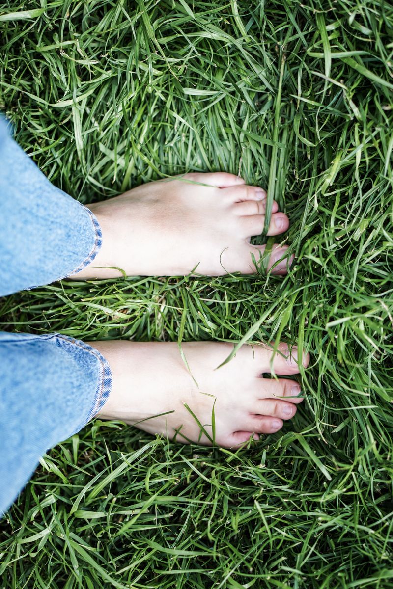 Bare feet standing in grass