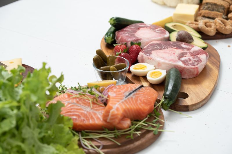 Keto-friendly foods: salmon, avocado, eggs, meat, greens
