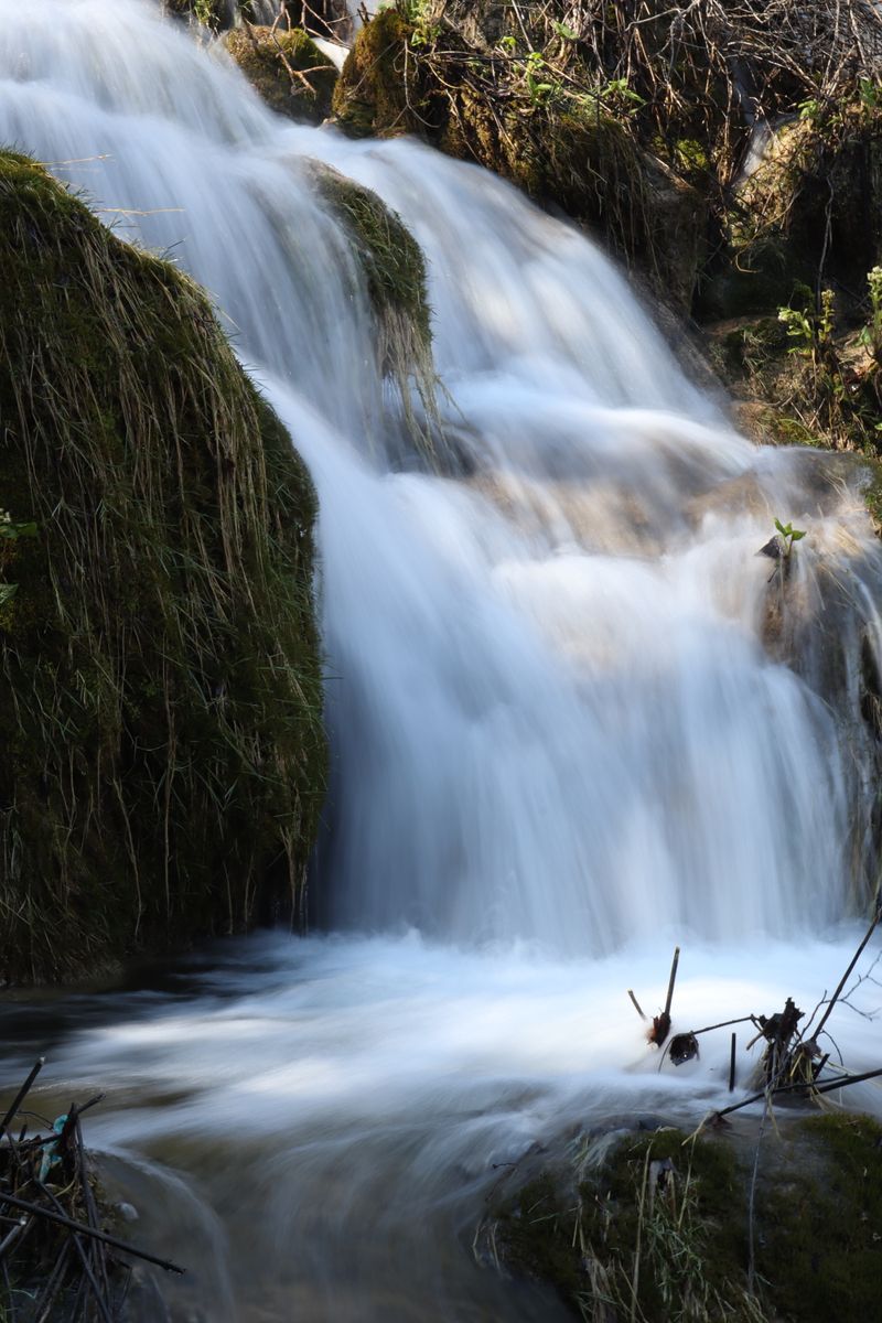 Cascading waterfall over mossy rocks