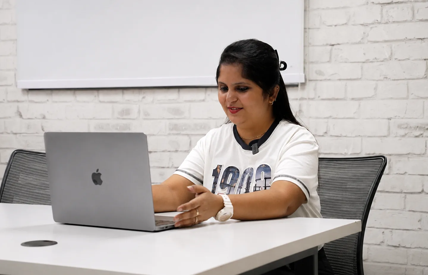 A Plaxonic team member at work during a hiring conversation