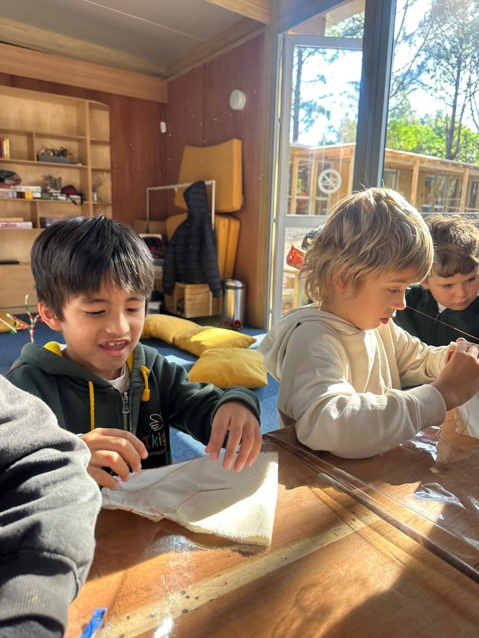 Niños y niñas construyendo bolsitas de semillas