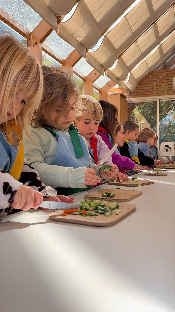 Niños y niñas creando con ramas y pintura