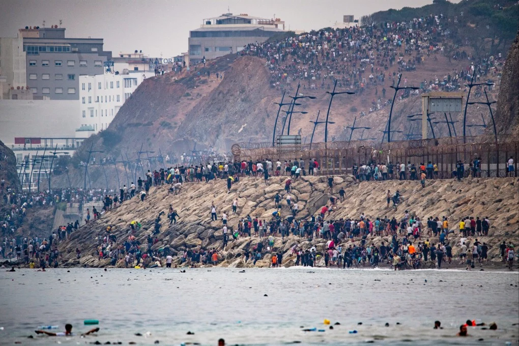 An Unprecedented mass of about 50,000-60,000 migrants crossing occurred at Ceuta, the Spanish autonomous city on the North African coast bordering Morocco.